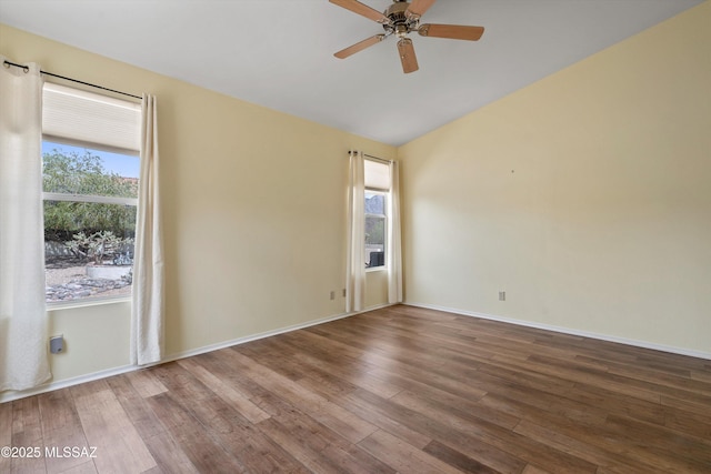 36973 S Highland Ridge Ct, Tucson, AZ 85739 - spare room with plenty of natural light, wood finished floors, a ceiling fan, vaulted ceiling, and baseboards