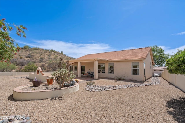 36973 S Highland Ridge Ct, Tucson, AZ 85739 - back of house featuring a tile roof, stucco siding, a fenced backyard, and a patio area
