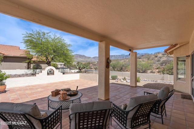 36973 S Highland Ridge Ct, Tucson, AZ 85739 - fenced backyard with a mountain view, a patio, and outdoor dining space