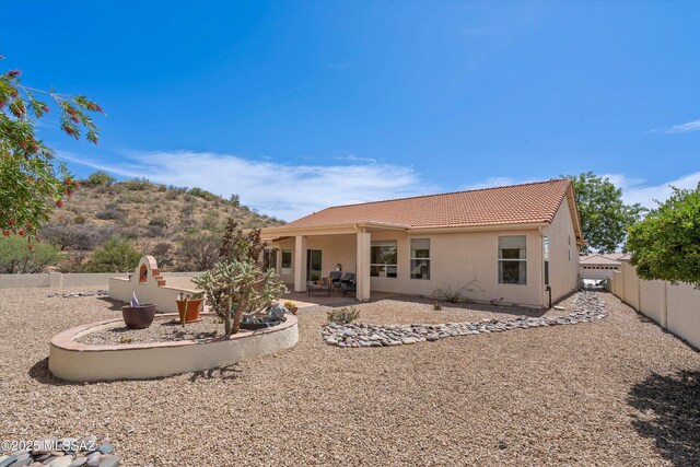 36973 S Highland Ridge Ct, Tucson, AZ 85739 - back of house featuring a tile roof, stucco siding, a fenced backyard, and a patio area