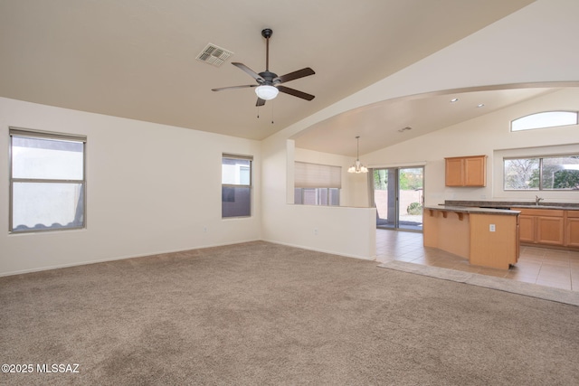 154 W Calle Patio Lindo, Sahuarita, AZ 85629 - unfurnished living room with a sink, light colored carpet, a ceiling fan, a chandelier, and baseboards