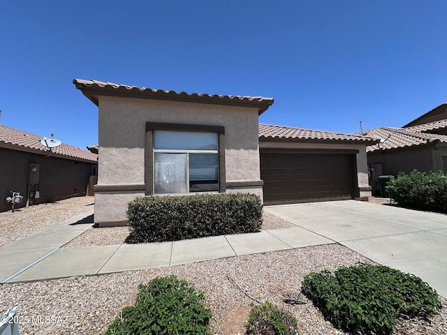 154 W Calle Patio Lindo, Sahuarita, AZ 85629 - view of front of home featuring stucco siding, an attached garage, concrete driveway, and a tile roof