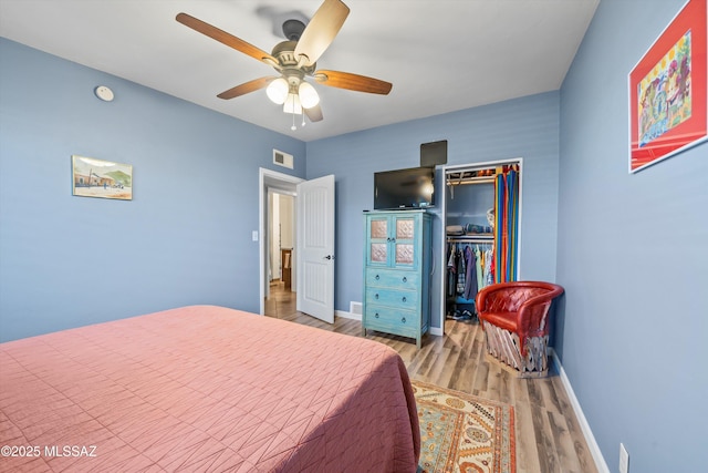 1912 W Anklam Rd, Tucson, AZ 85745 - bedroom featuring wood finished floors, a closet, baseboards, and ceiling fan