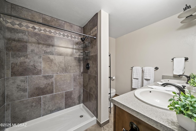 1912 W Anklam Rd, Tucson, AZ 85745 - bathroom with tiled shower, double vanity, toilet, and baseboards
