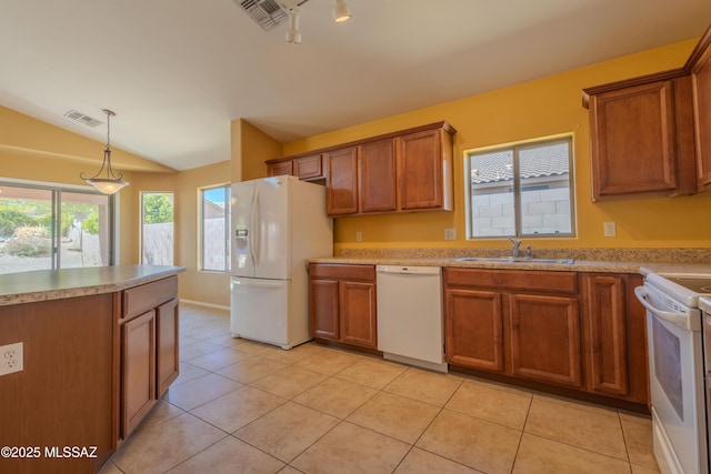 kitchen with lofted ceiling, white appliances, a sink, visible vents, and brown cabinetry