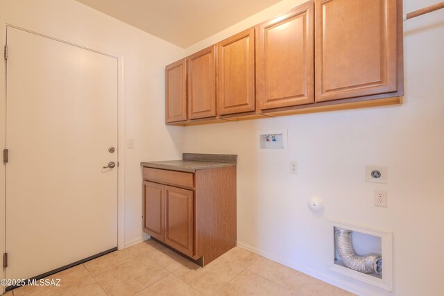 laundry area with washer hookup, baseboards, electric dryer hookup, cabinet space, and light tile patterned floors