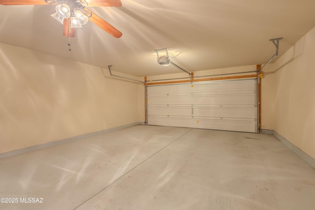garage featuring a garage door opener, ceiling fan, and baseboards