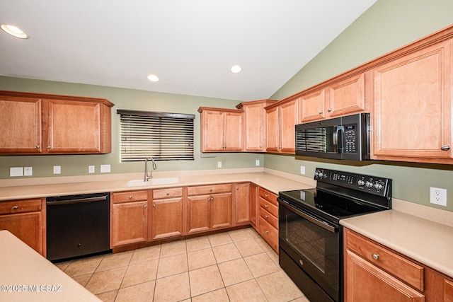 kitchen featuring black appliances, a sink, light countertops, light tile patterned floors, and lofted ceiling