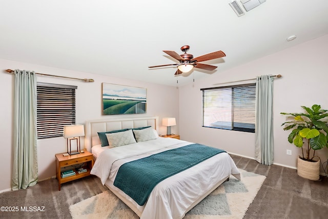 carpeted bedroom featuring visible vents, lofted ceiling, baseboards, and a ceiling fan