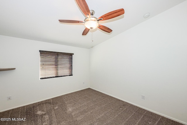 carpeted spare room featuring baseboards and ceiling fan