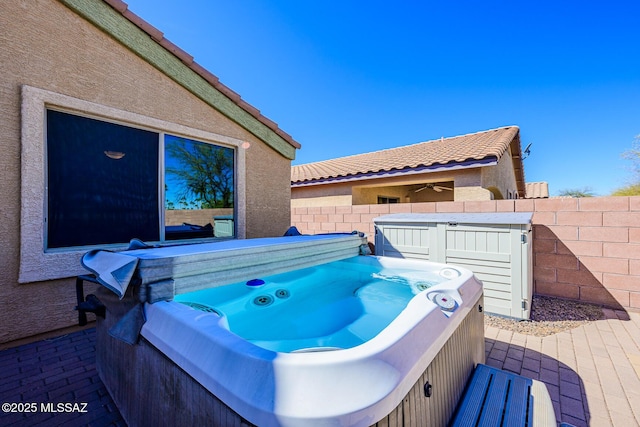 view of patio with a hot tub and a fenced backyard