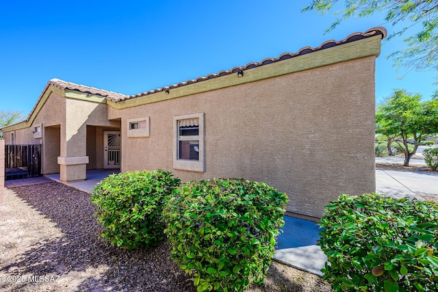 view of home's exterior featuring stucco siding and a tiled roof