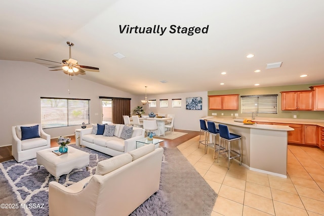 living room with visible vents, light tile patterned flooring, recessed lighting, ceiling fan, and vaulted ceiling