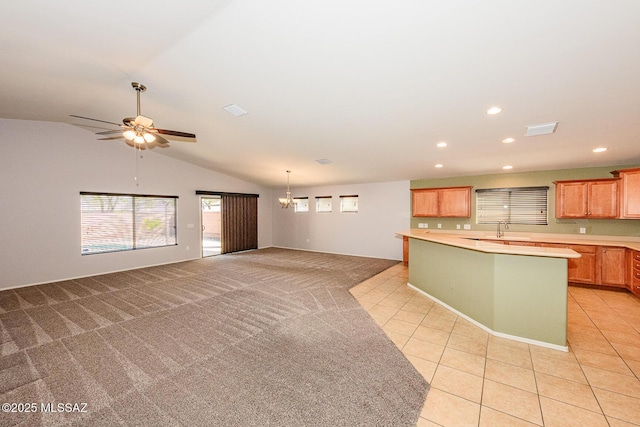 kitchen featuring light colored carpet, light tile patterned flooring, vaulted ceiling, and light countertops