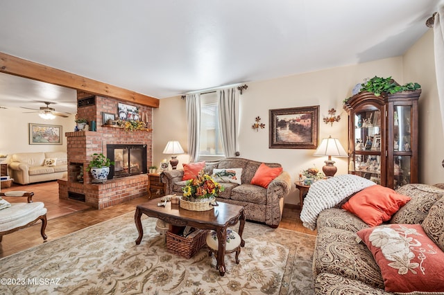 living area with a brick fireplace and ceiling fan