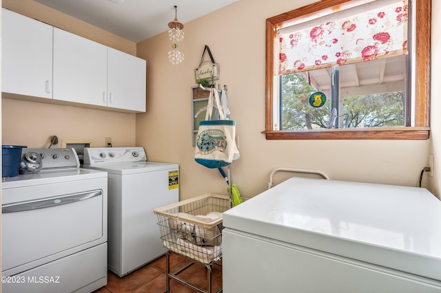 laundry area with cabinet space, washer and dryer, and tile patterned floors