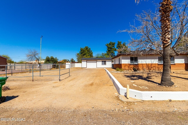 view of front facade featuring brick siding, a garage, and fence