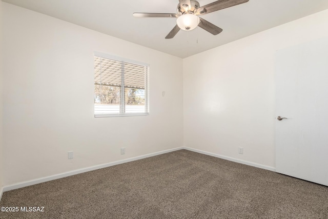 carpeted spare room with baseboards and ceiling fan