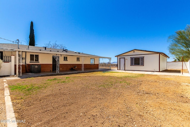 back of property featuring cooling unit, a patio, an outdoor structure, and fence