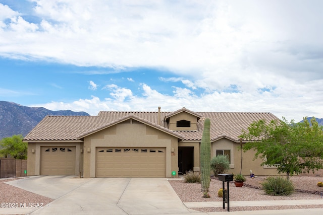 14938 N Gwynns Run Dr, Tucson, AZ 85739 - view of front of house featuring stucco siding, an attached garage, driveway, a tile roof, and a mountain view
