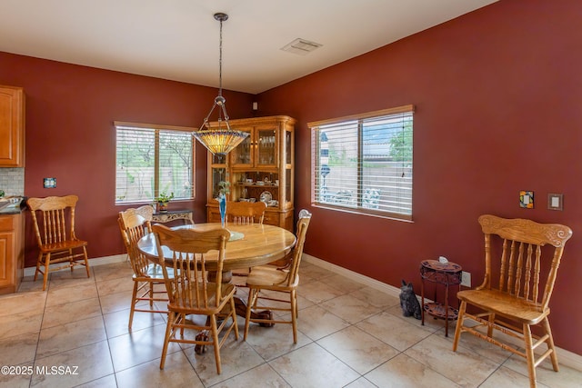 14938 N Gwynns Run Dr, Tucson, AZ 85739 - dining space with healthy amount of natural light, baseboards, and light tile patterned floors