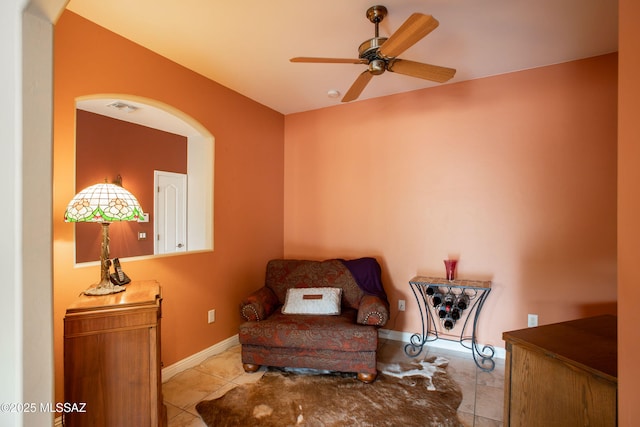 14938 N Gwynns Run Dr, Tucson, AZ 85739 - living area featuring arched walkways, a ceiling fan, baseboards, and tile patterned flooring