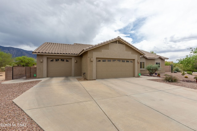14938 N Gwynns Run Dr, Tucson, AZ 85739 - view of front of property featuring stucco siding, driveway, a garage, a mountain view, and a tile roof