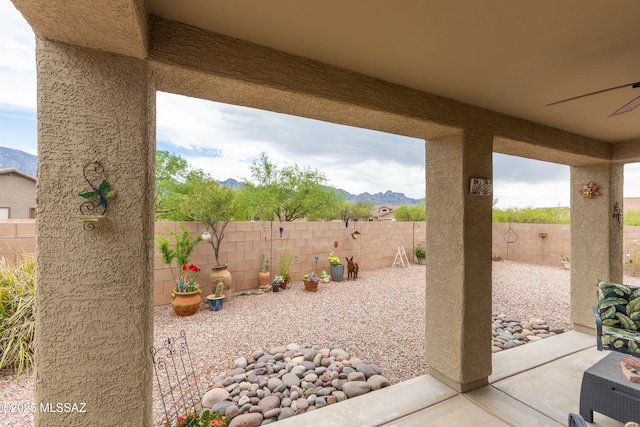 14938 N Gwynns Run Dr, Tucson, AZ 85739 - fenced backyard with a ceiling fan, a mountain view, and a patio
