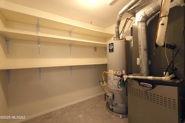 utility room featuring heating unit and water heater