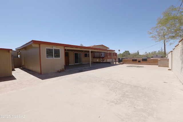 back of property with a patio area and fence