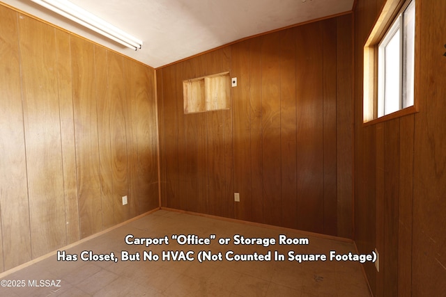 spare room with wood walls