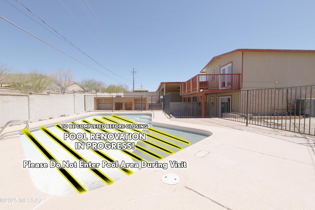view of swimming pool with a patio, central air condition unit, fence, and a fenced in pool