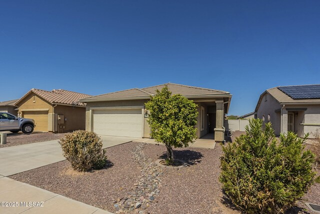 20868 E Treasure Rd, Red Rock, AZ 85145 - view of front of home featuring a tiled roof, stucco siding, driveway, and an attached garage