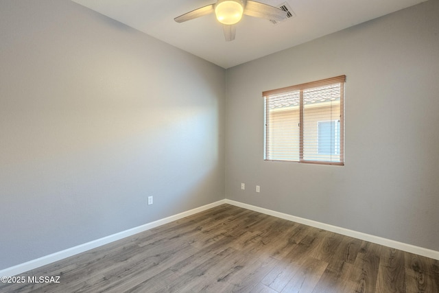 20868 E Treasure Rd, Red Rock, AZ 85145 - unfurnished room featuring visible vents, baseboards, wood finished floors, and a ceiling fan