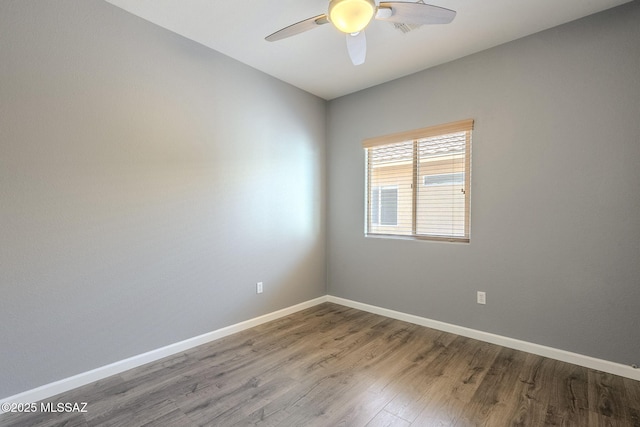 20868 E Treasure Rd, Red Rock, AZ 85145 - unfurnished room with baseboards, wood finished floors, and ceiling fan