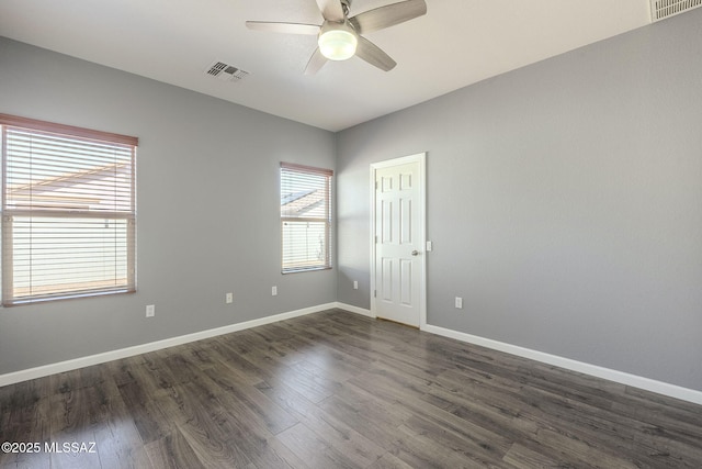 20868 E Treasure Rd, Red Rock, AZ 85145 - spare room featuring dark wood finished floors, visible vents, baseboards, and ceiling fan