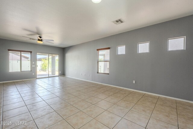 20868 E Treasure Rd, Red Rock, AZ 85145 - empty room with light tile patterned floors, visible vents, baseboards, and a ceiling fan