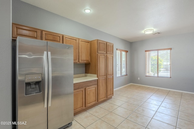 20868 E Treasure Rd, Red Rock, AZ 85145 - kitchen featuring visible vents, light tile patterned flooring, stainless steel fridge with ice dispenser, light countertops, and baseboards