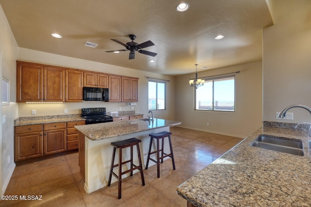 9505 S Deer Ridge Trl, Hereford, AZ 85615 - kitchen featuring visible vents, black appliances, brown cabinets, and a sink