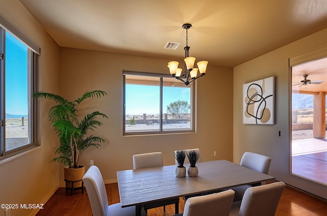 9505 S Deer Ridge Trl, Hereford, AZ 85615 - dining area with wood finished floors, a chandelier, visible vents, and baseboards