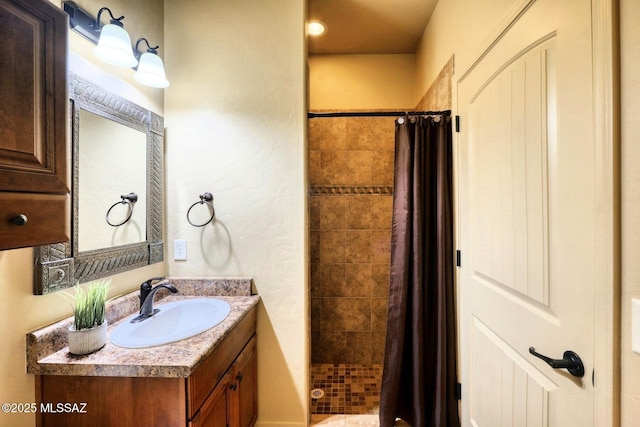 9505 S Deer Ridge Trl, Hereford, AZ 85615 - bathroom featuring a shower stall, a textured wall, and vanity