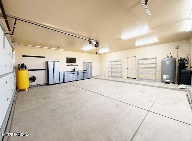 9505 S Deer Ridge Trl, Hereford, AZ 85615 - garage featuring a garage door opener and water heater