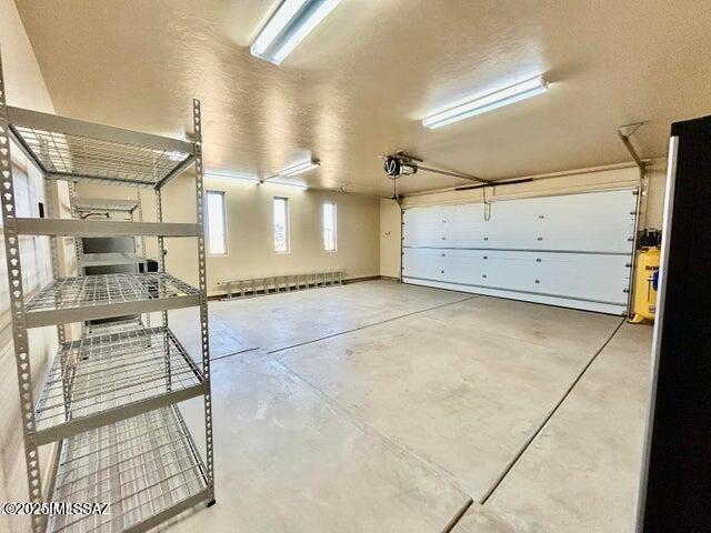 9505 S Deer Ridge Trl, Hereford, AZ 85615 - garage featuring a garage door opener