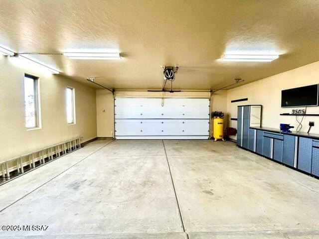 9505 S Deer Ridge Trl, Hereford, AZ 85615 - garage featuring a garage door opener