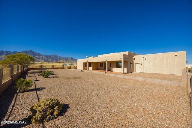 9505 S Deer Ridge Trl, Hereford, AZ 85615 - rear view of house featuring a patio, a mountain view, fence, and stucco siding