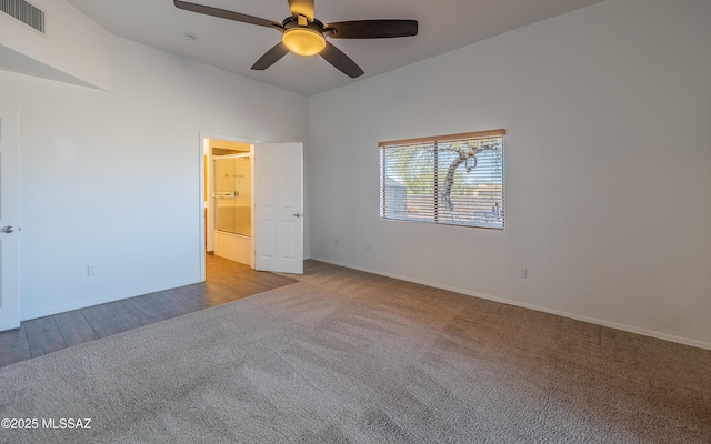 unfurnished bedroom with visible vents, a ceiling fan, carpet floors, baseboards, and vaulted ceiling