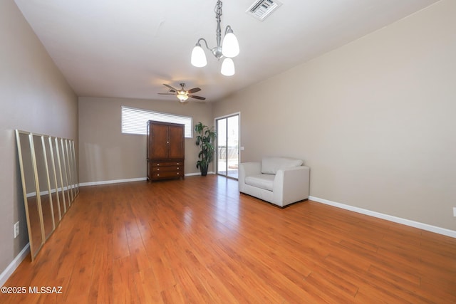 8418 N Sayante Way, Tucson, AZ 85743 - unfurnished room featuring baseboards, visible vents, light wood-style floors, and ceiling fan with notable chandelier