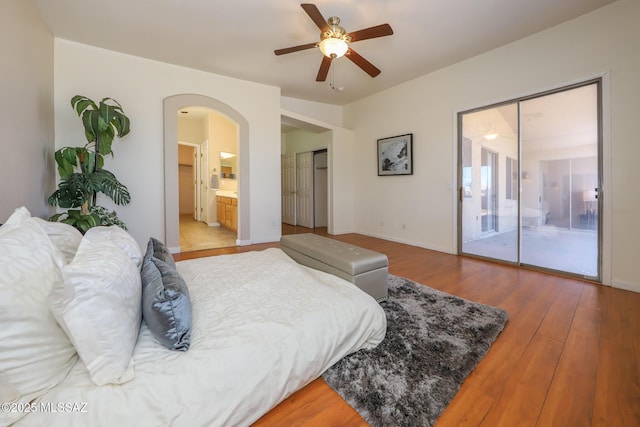 8418 N Sayante Way, Tucson, AZ 85743 - bedroom with arched walkways, baseboards, access to exterior, and wood finished floors