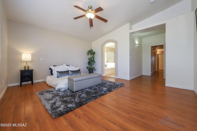 8418 N Sayante Way, Tucson, AZ 85743 - bedroom with arched walkways, baseboards, wood finished floors, and vaulted ceiling