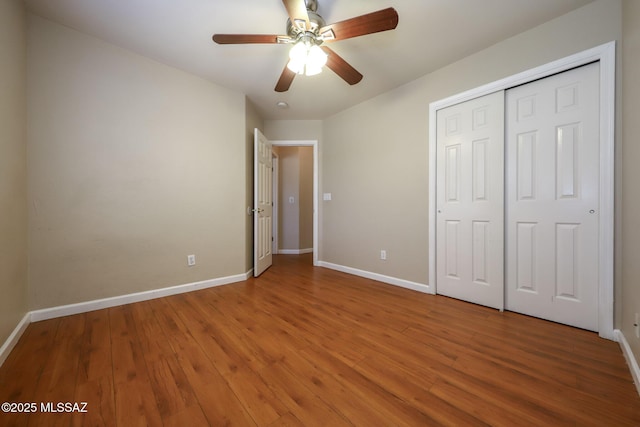 8418 N Sayante Way, Tucson, AZ 85743 - unfurnished bedroom featuring baseboards, ceiling fan, wood finished floors, and a closet